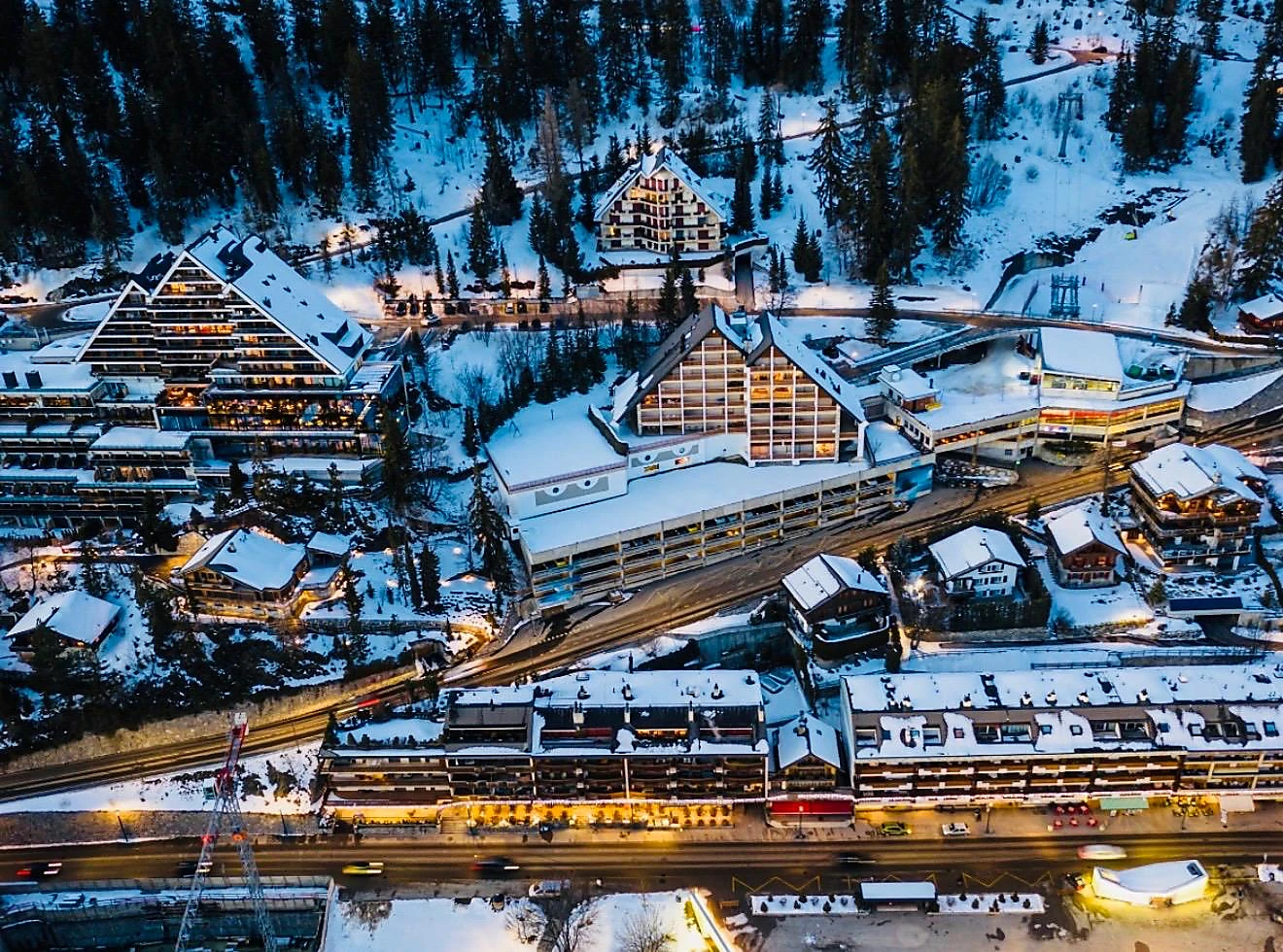 Aerial view of a snow-covered mountain resort at dusk